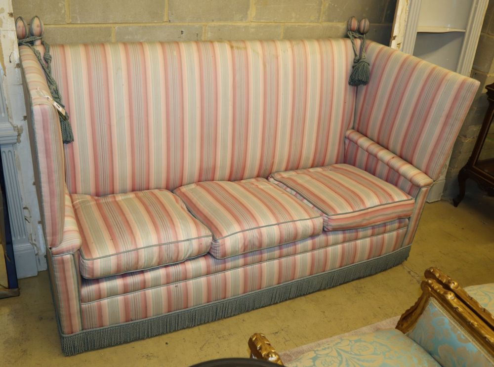A Knowle settee, upholstered in striped fabric, L.192cm, D.80cm, H.116cm